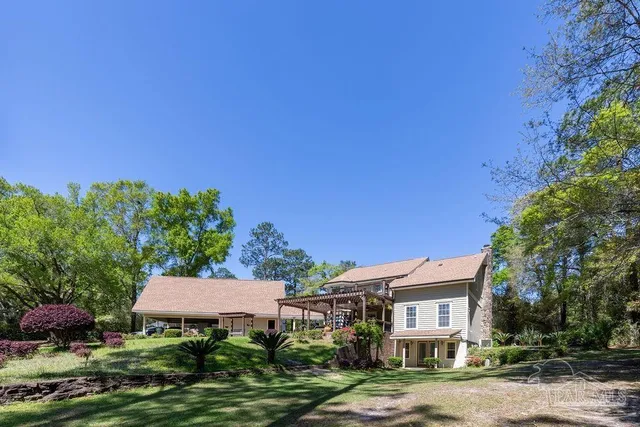 a view of a house with swimming pool and porch with furniture