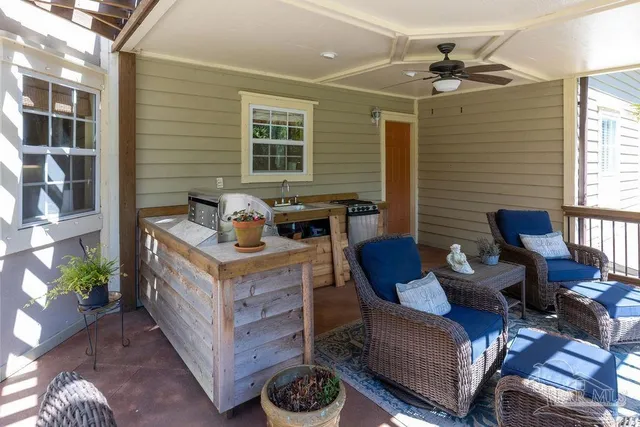 a living room with patio furniture and a floor to ceiling window