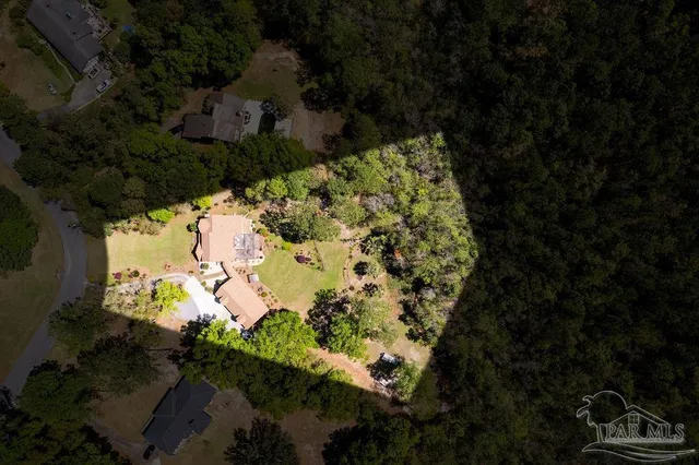 a aerial view of a house with a yard and garden