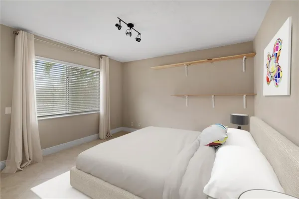 a bedroom with a bed and a window