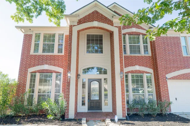 front view of a brick house with a large windows