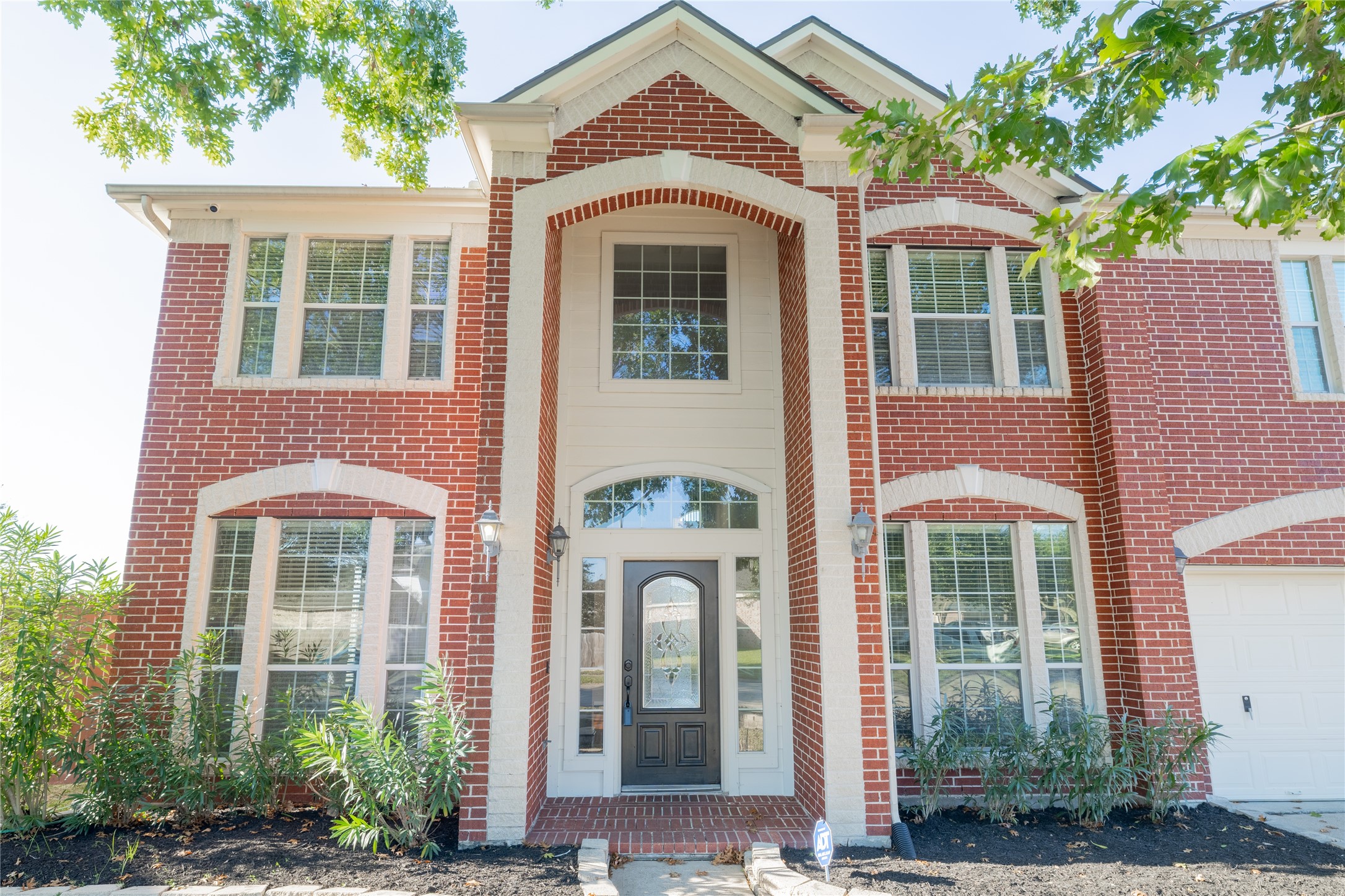 front view of a brick house with a large windows