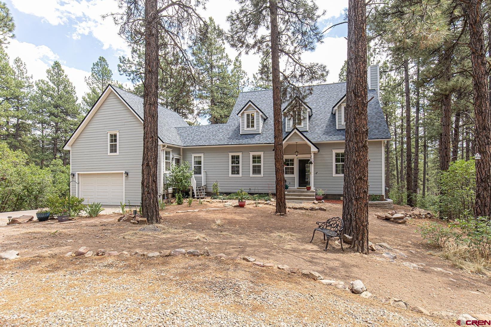 383 The Eagle Pass Durango, CO 81301 - Photo 1 of 37 a front view of a house with a tree in it