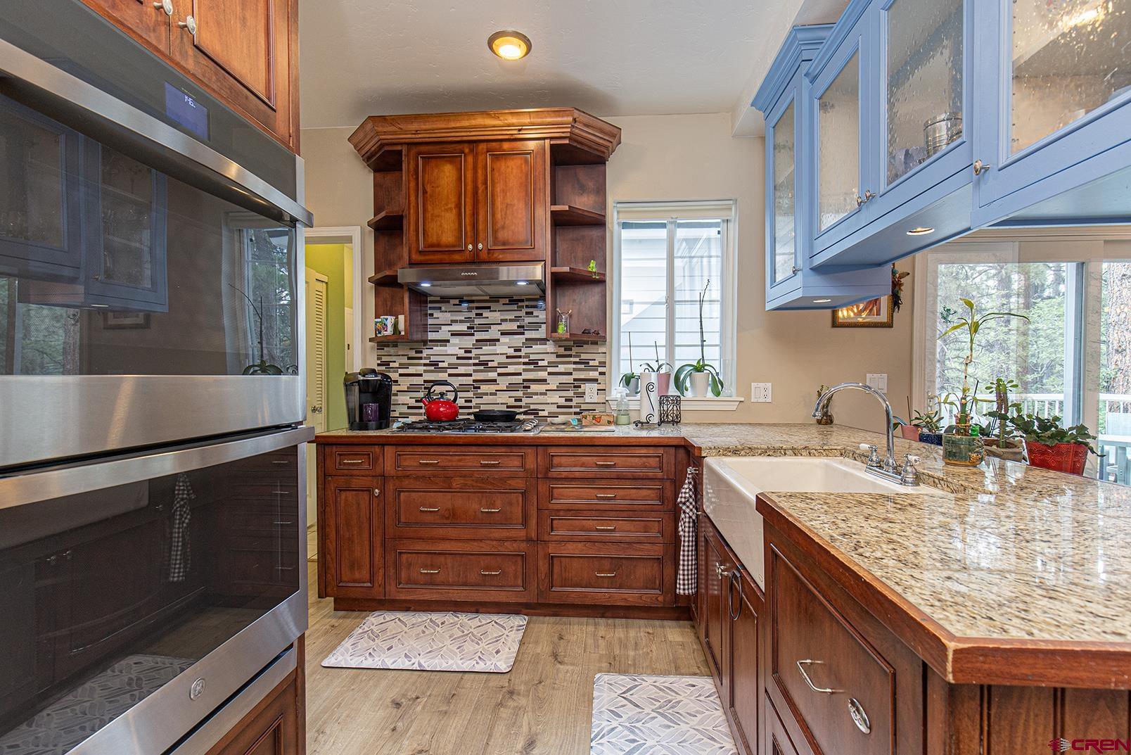 383 The Eagle Pass Durango, CO 81301 - Photo 11 of 37 a kitchen with stainless steel appliances granite countertop a sink and a stove
