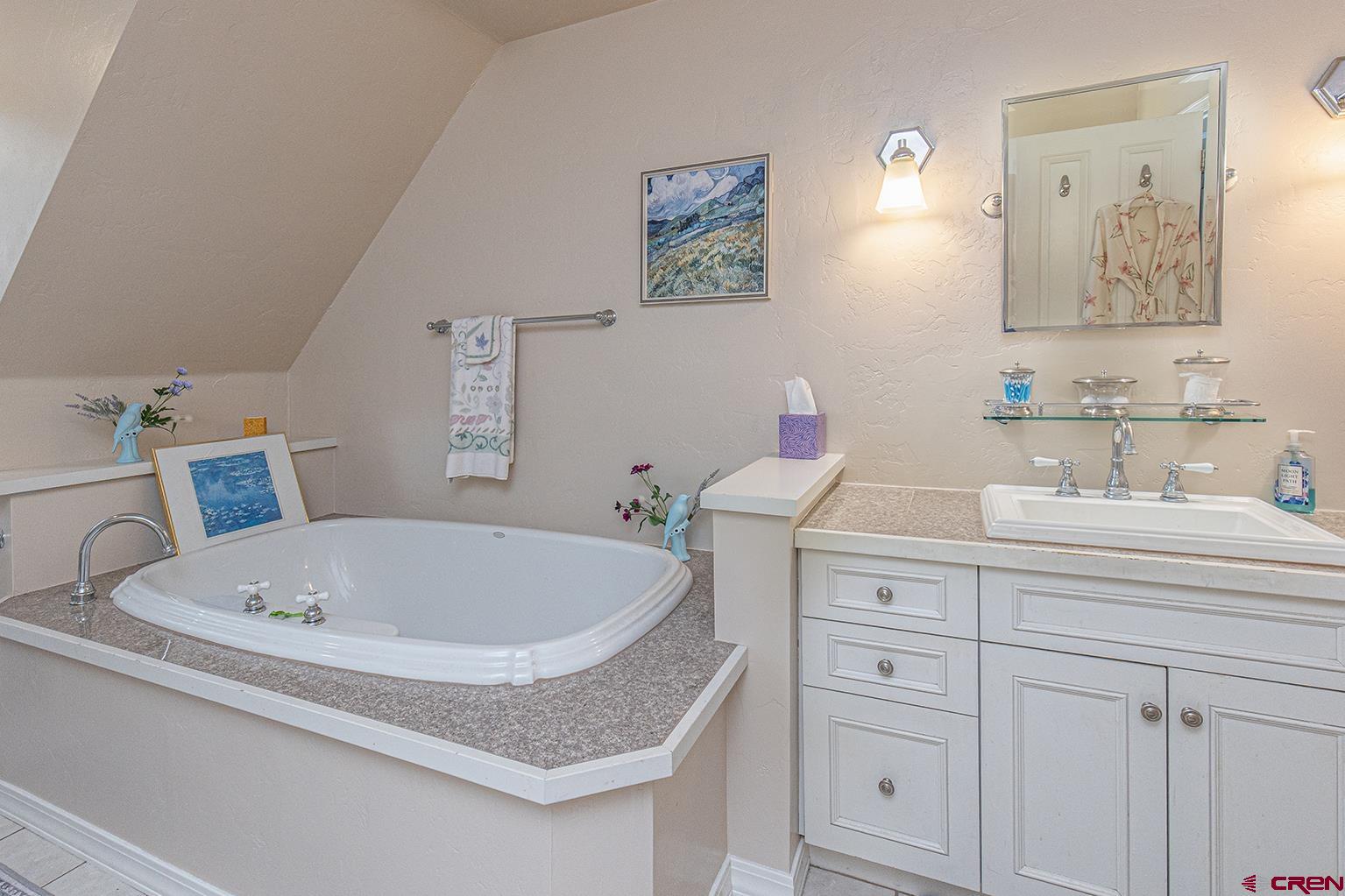 383 The Eagle Pass Durango, CO 81301 - Photo 19 of 37 a bathroom with a tub sink and mirror