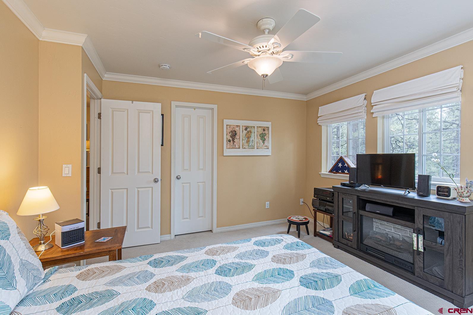 383 The Eagle Pass Durango, CO 81301 - Photo 20 of 37 a bedroom with furniture and a chandelier