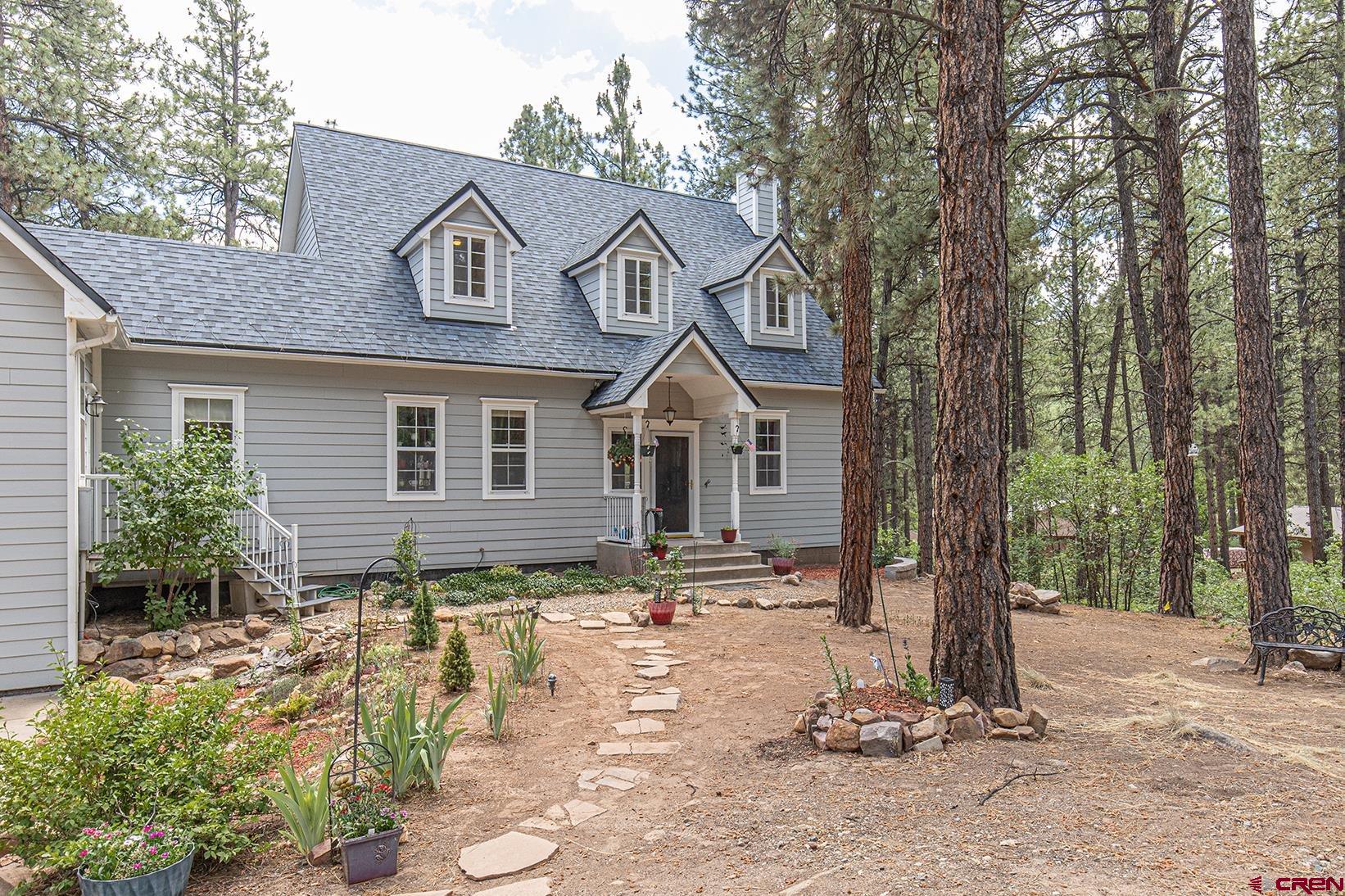 383 The Eagle Pass Durango, CO 81301 - Photo 2 of 37 a front view of a house with a yard