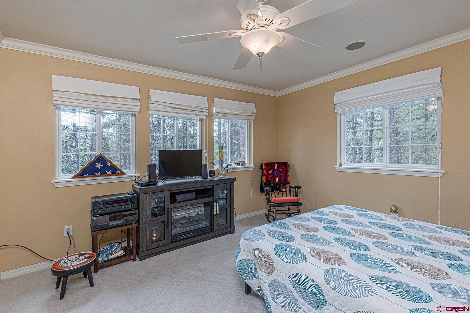 383 The Eagle Pass Durango, CO 81301 - Photo 21 of 37 a bedroom with a bed and a chandelier