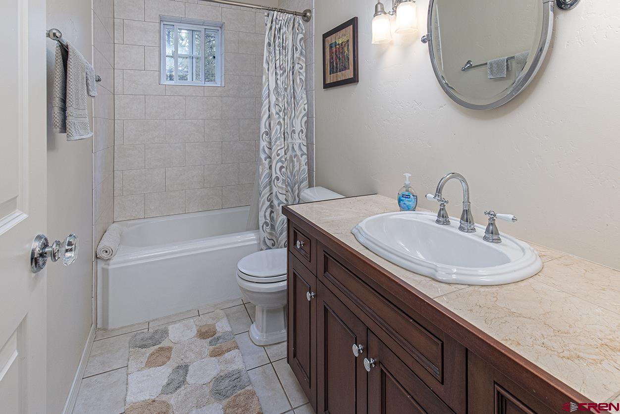 383 The Eagle Pass Durango, CO 81301 - Photo 24 of 37 a bathroom with a sink a toilet and a mirror