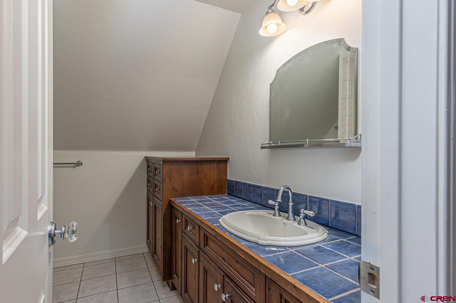 383 The Eagle Pass Durango, CO 81301 - Photo 28 of 37 a bathroom with a sink and a mirror