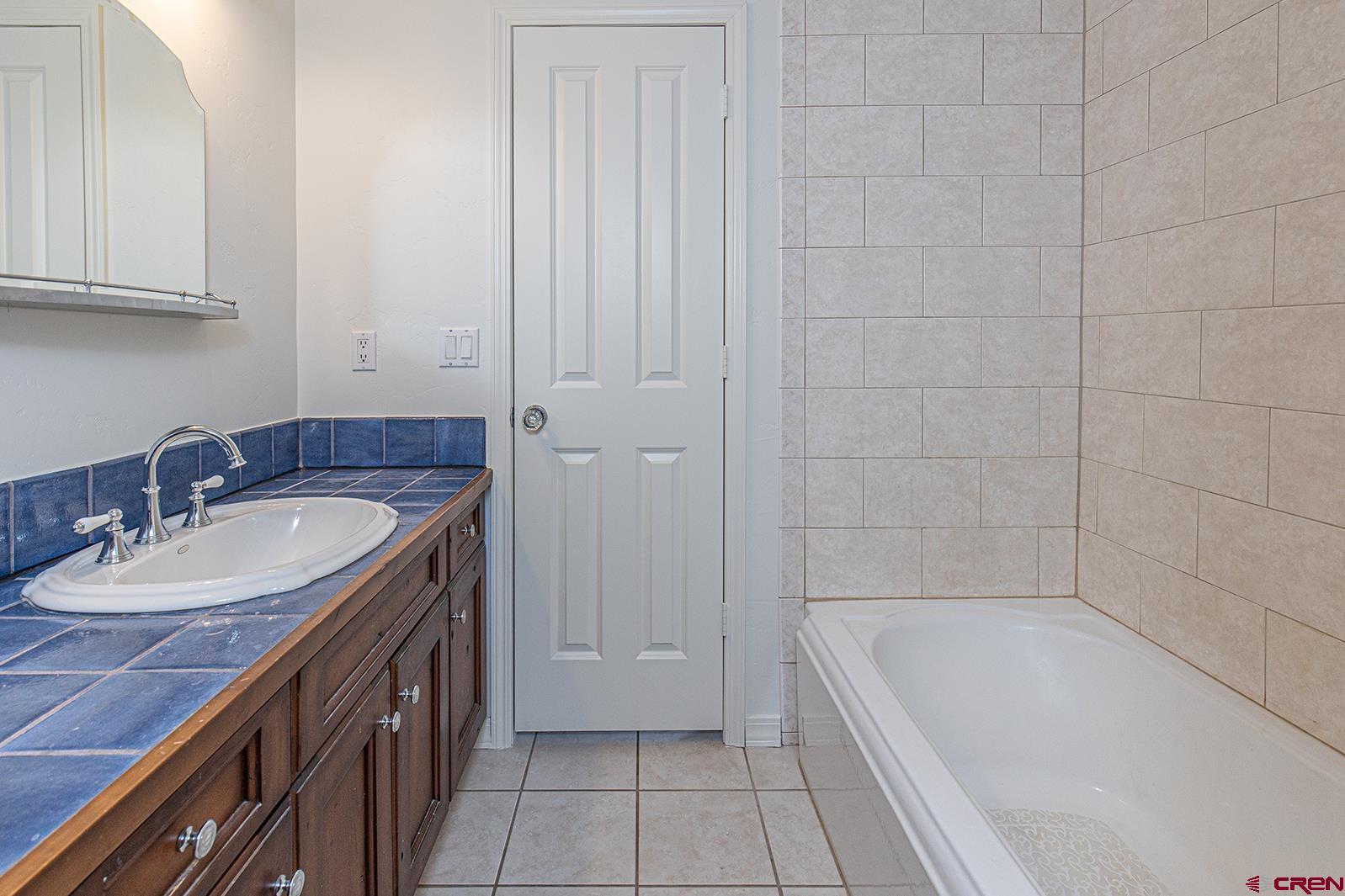 383 The Eagle Pass Durango, CO 81301 - Photo 29 of 37 a bathroom with a granite countertop sink and a bathtub