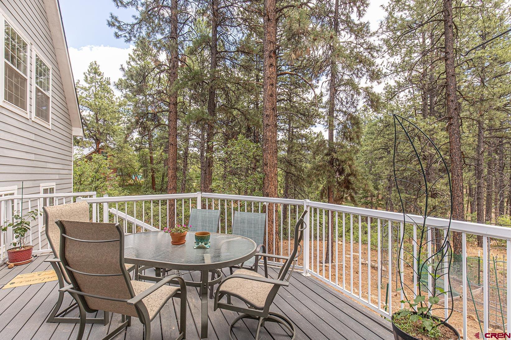 383 The Eagle Pass Durango, CO 81301 - Photo 31 of 37 a view of a patio with table and chairs and wooden floor