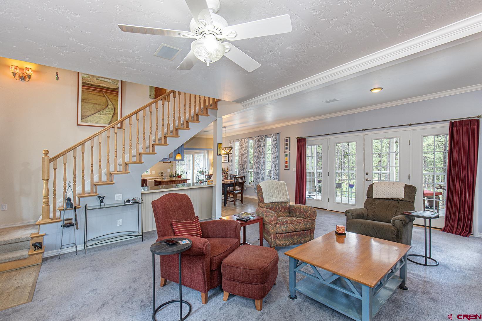 383 The Eagle Pass Durango, CO 81301 - Photo 6 of 37 a living room with furniture ceiling fan and a rug