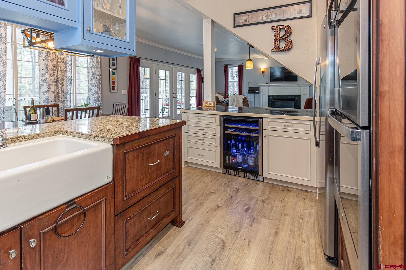 383 The Eagle Pass Durango, CO 81301 - Photo 10 of 37 a kitchen with stainless steel appliances granite countertop a refrigerator a sink dishwasher a stove and white countertops with wooden floor