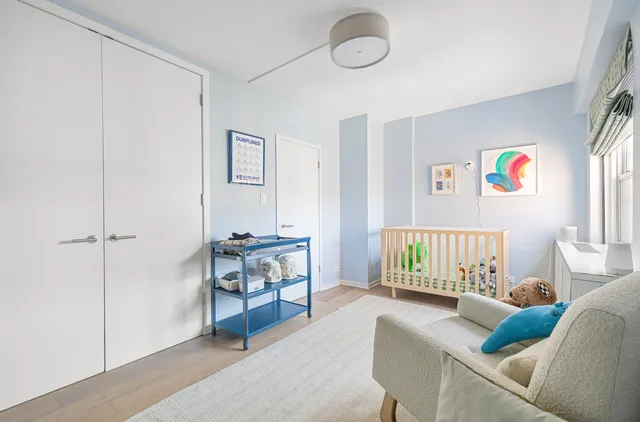 a bedroom with furniture and a book shelf