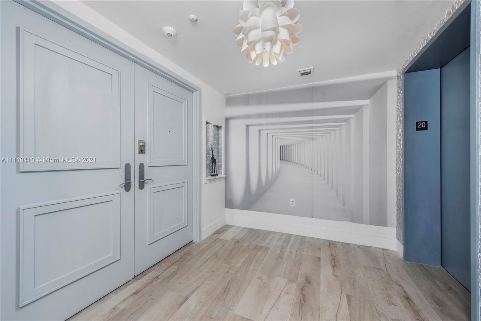 400 Alton Road, Unit 2003 Miami Beach, FL 33139 - Photo 2 of 38 wooden floor in an empty room with a window