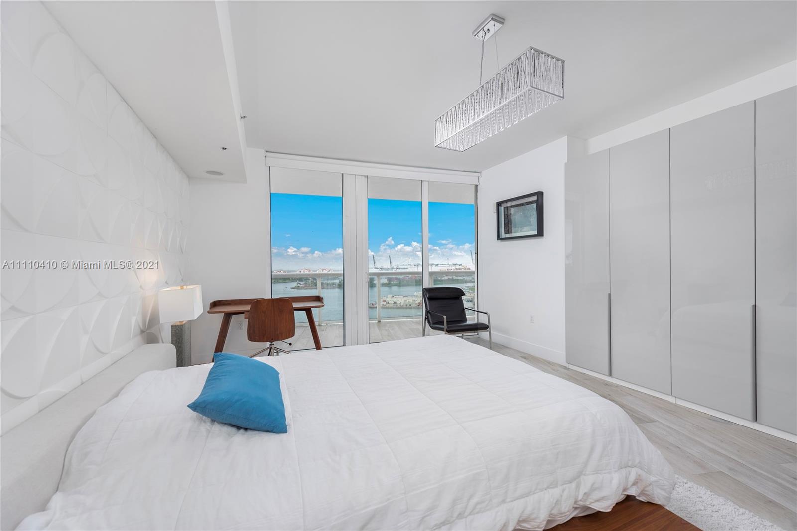 400 Alton Road, Unit 2003 Miami Beach, FL 33139 - Photo 13 of 38 a bedroom with a large bed and white walls