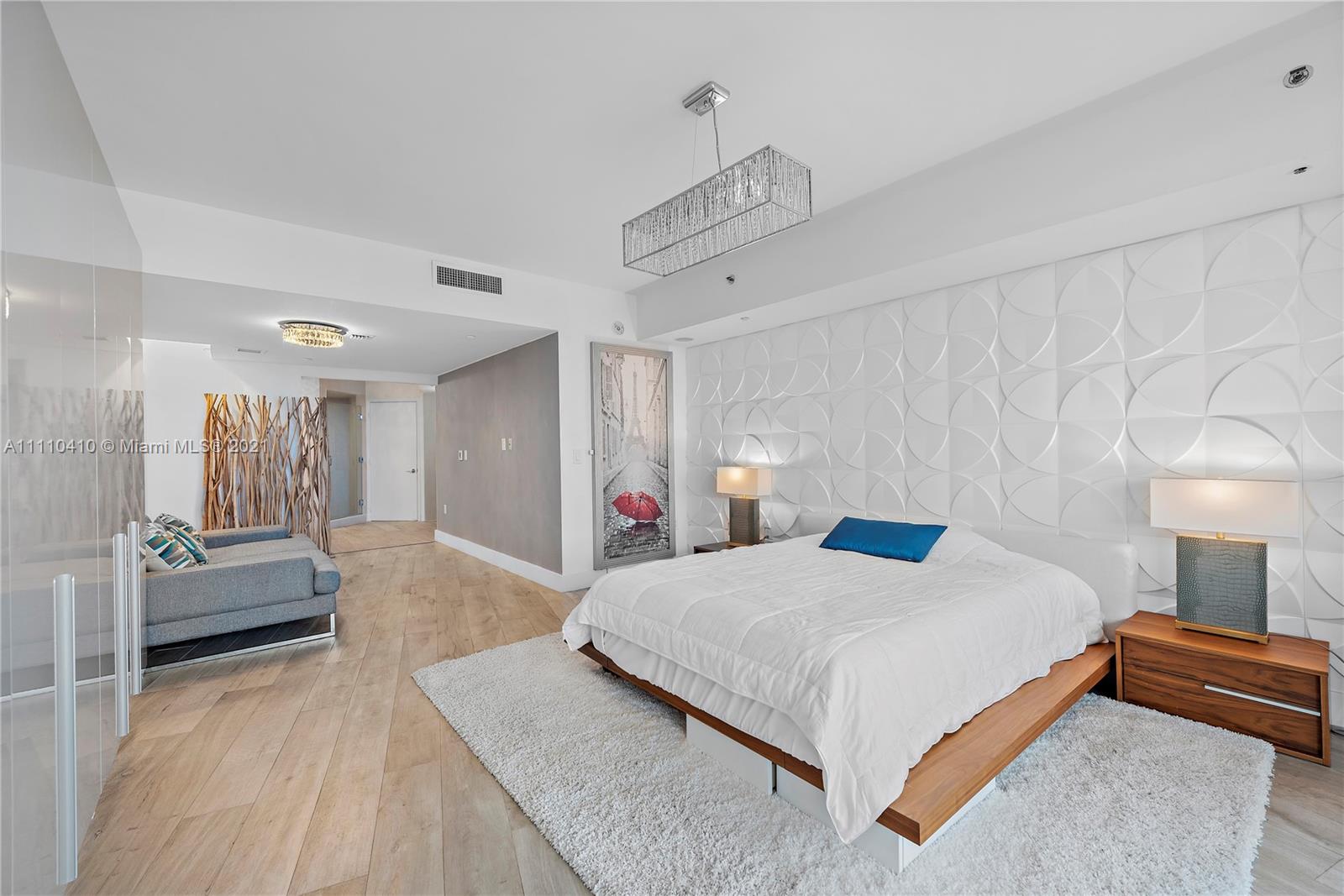 400 Alton Road, Unit 2003 Miami Beach, FL 33139 - Photo 16 of 38 a bedroom with a bed and a couch