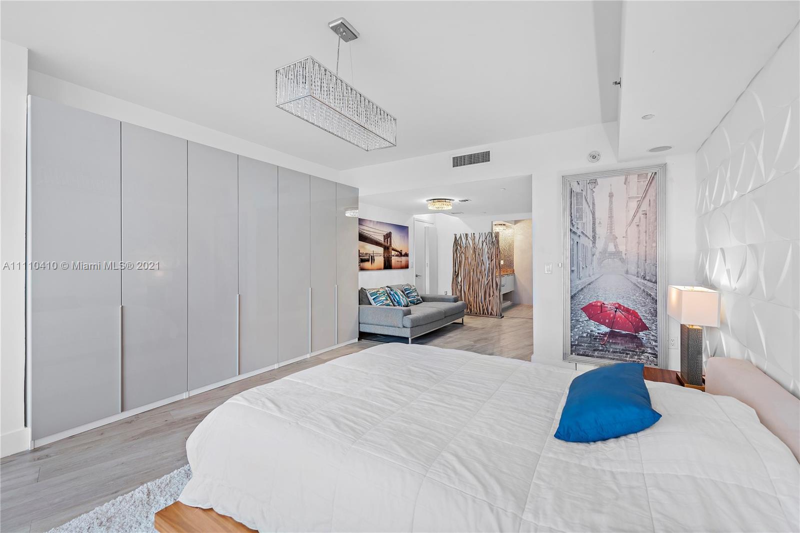 400 Alton Road, Unit 2003 Miami Beach, FL 33139 - Photo 17 of 38 a bedroom with a bed and a couch