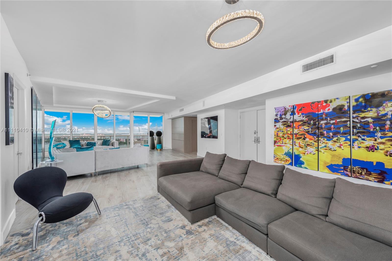 400 Alton Road, Unit 2003 Miami Beach, FL 33139 - Photo 3 of 38 a living room with furniture a rug and a large window