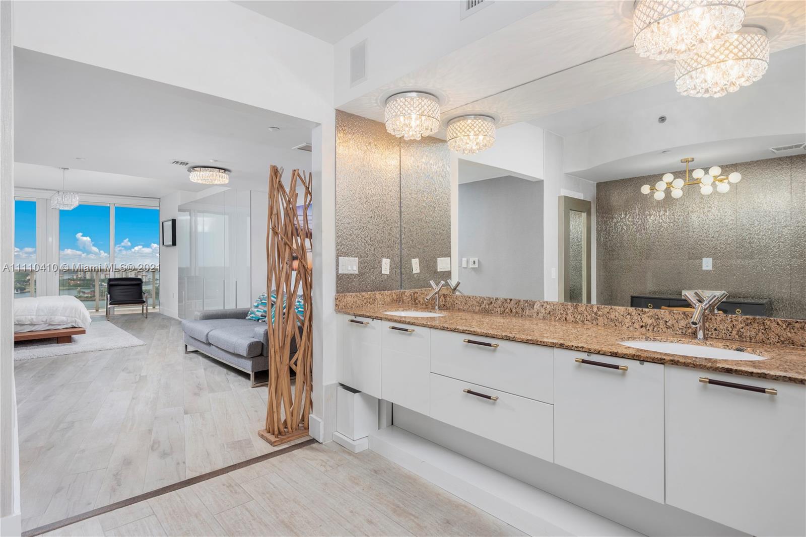 400 Alton Road, Unit 2003 Miami Beach, FL 33139 - Photo 21 of 38 a bathroom with a sink and a large mirror
