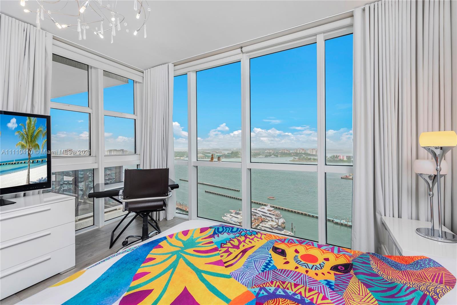 400 Alton Road, Unit 2003 Miami Beach, FL 33139 - Photo 23 of 38 a bedroom that has a bed and a table in it