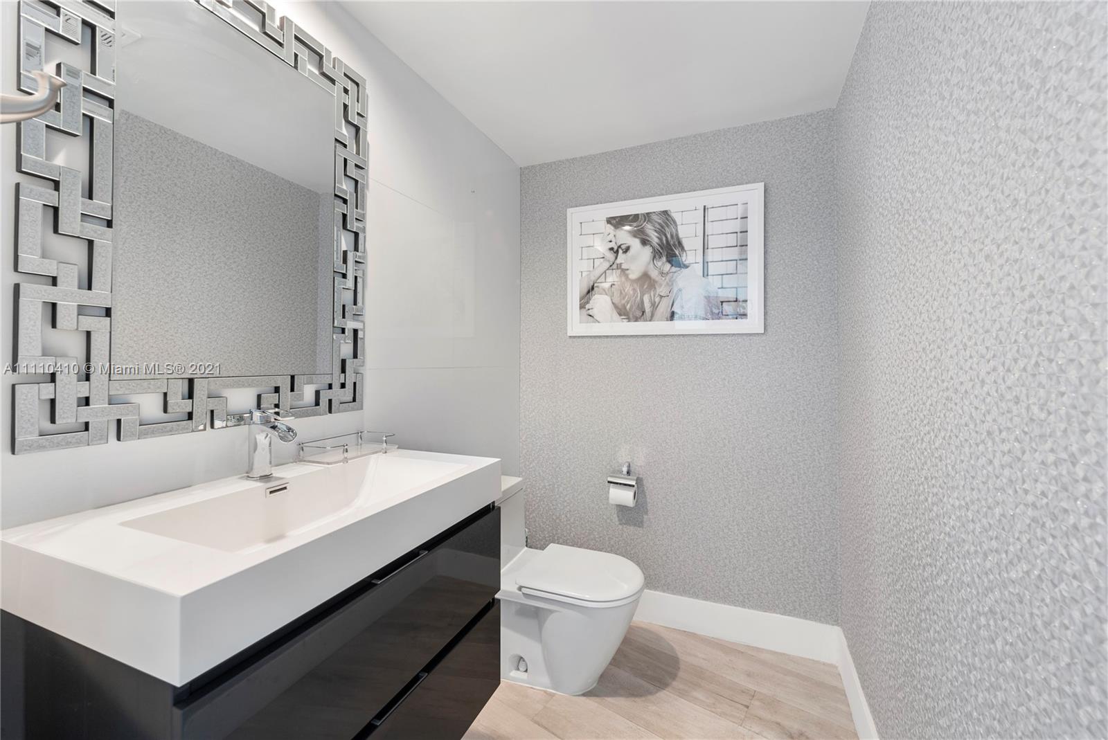 400 Alton Road, Unit 2003 Miami Beach, FL 33139 - Photo 25 of 38 a bathroom with a sink mirror and toilet