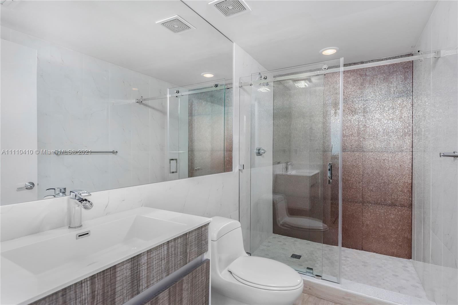 400 Alton Road, Unit 2003 Miami Beach, FL 33139 - Photo 27 of 38 a bathroom with a sink toilet and shower