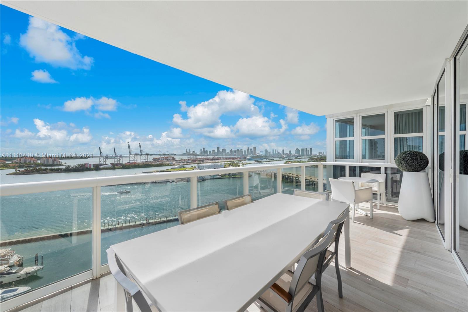 400 Alton Road, Unit 2003 Miami Beach, FL 33139 - Photo 30 of 38 a view of a balcony with a table and chairs