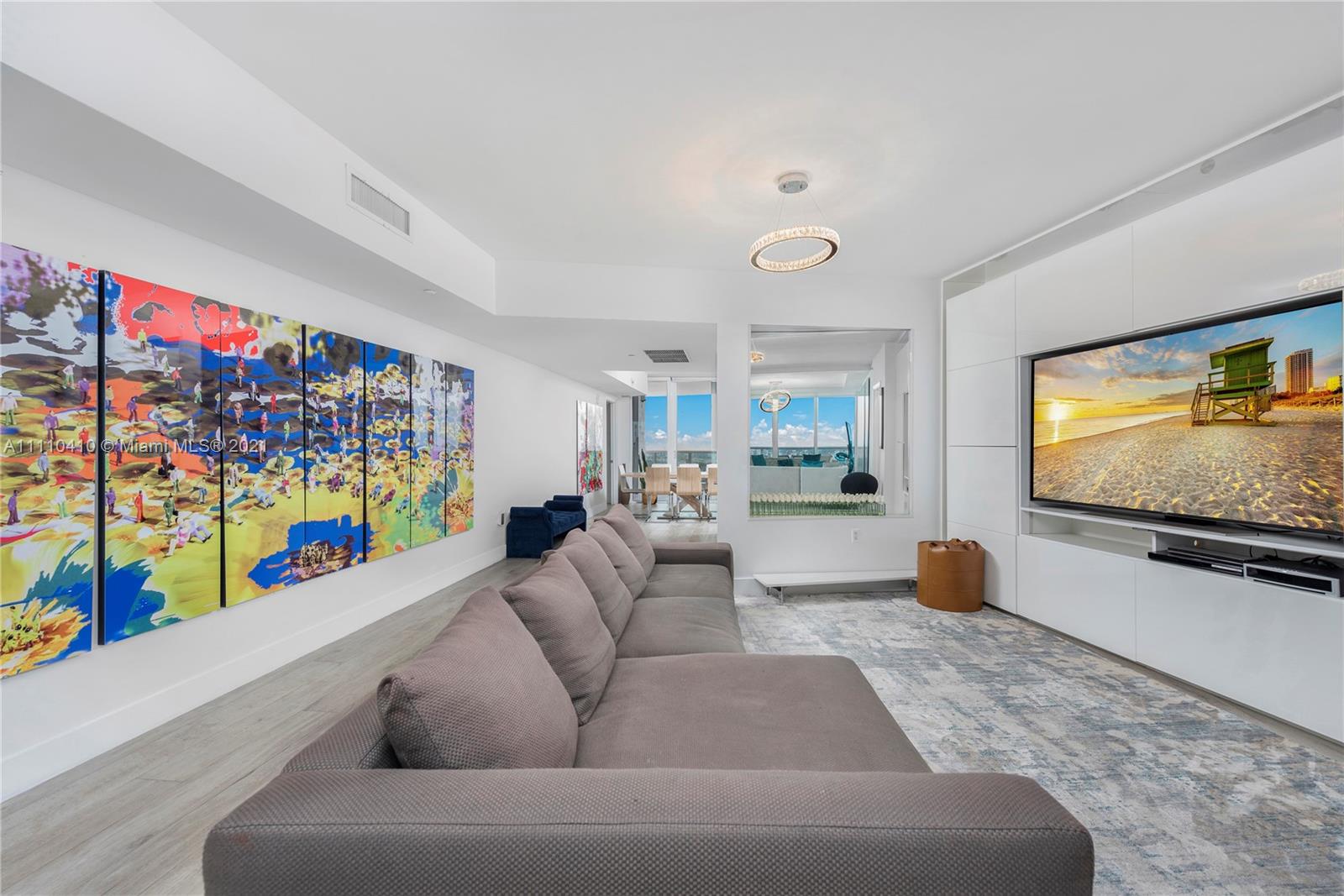 400 Alton Road, Unit 2003 Miami Beach, FL 33139 - Photo 4 of 38 a living room with furniture and a flat screen tv