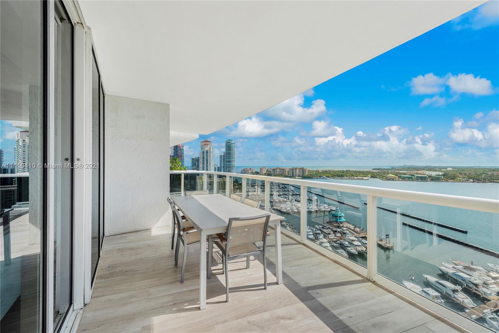 400 Alton Road, Unit 2003 Miami Beach, FL 33139 - Photo 34 of 38 a view of a terrace with furniture and a floor to ceiling window