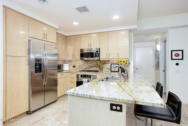 a kitchen with kitchen island a counter appliances and refrigerator