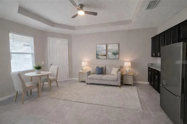 a kitchen with kitchen island granite countertop stainless steel appliances a sink cabinets and a window