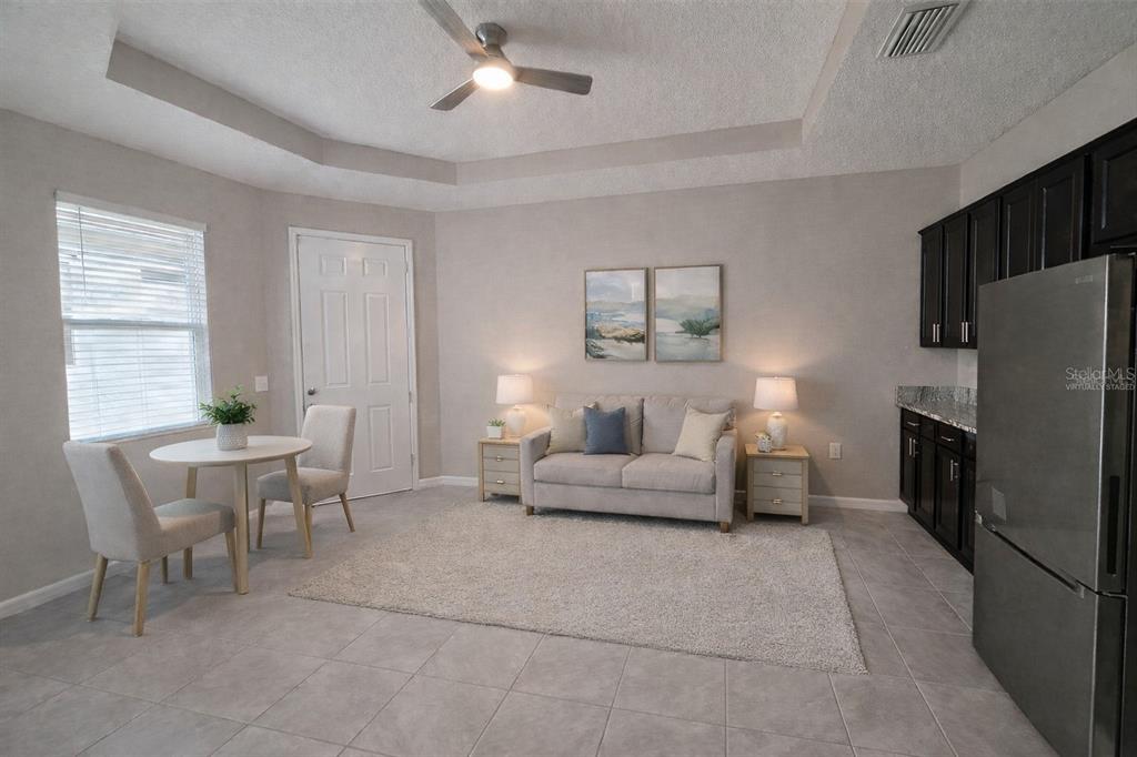 13483 Golden Lime Ave Spring Hill Spring Hill, FL 34609 - Photo 13 of 92 a living room with furniture a large window and a refrigerator