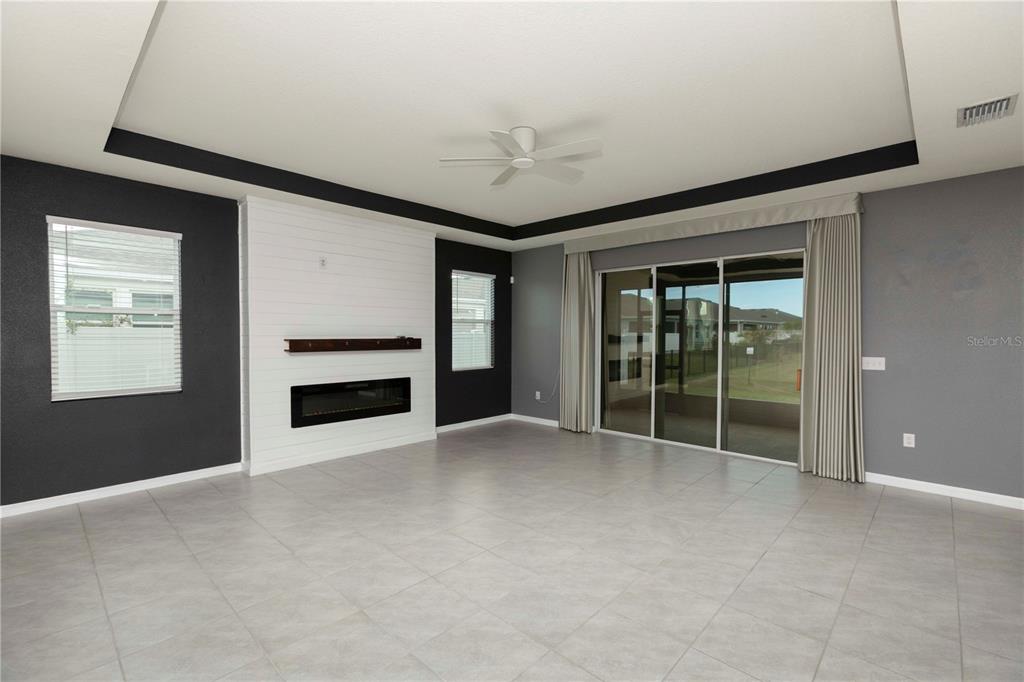 13483 Golden Lime Ave Spring Hill Spring Hill, FL 34609 - Photo 17 of 92 a view of an empty room with a fireplace and a window