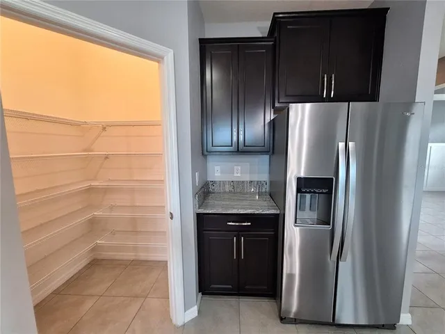 an empty room with wooden floor closet and windows