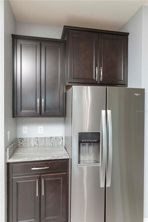 13483 Golden Lime Ave Spring Hill Spring Hill, FL 34609 - Photo 25 of 92 a kitchen with stainless steel appliances granite countertop wood cabinets and refrigerator