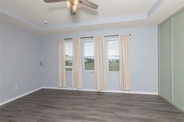 a kitchen with stainless steel appliances a refrigerator and a ceiling fan