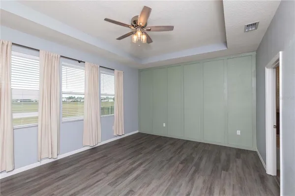 a view of kitchen with refrigerator stove and cabinets