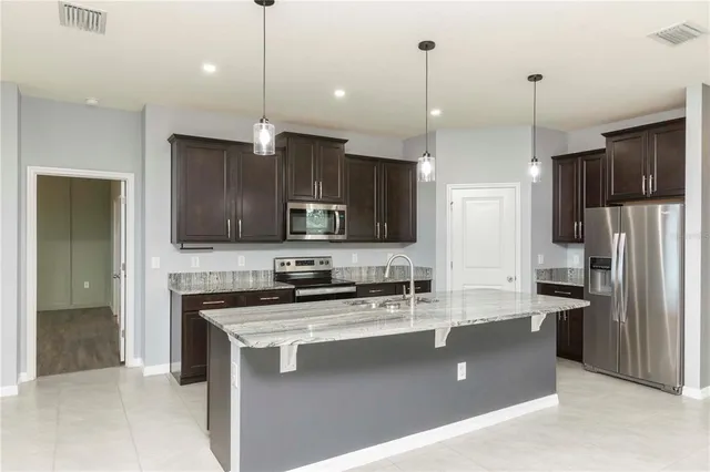 a front view of house with yard and trees