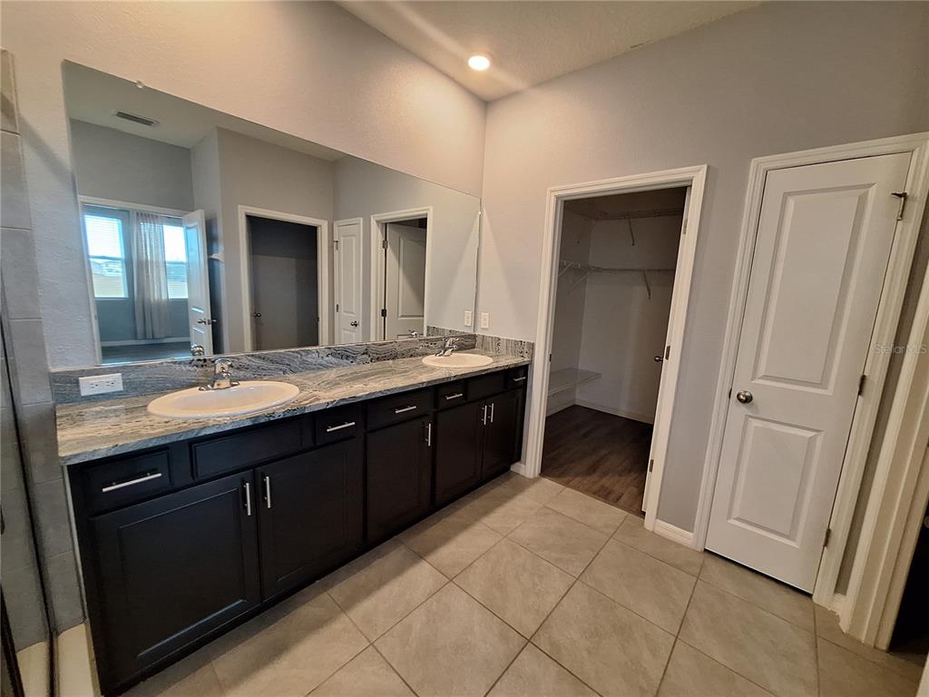 13483 Golden Lime Ave Spring Hill Spring Hill, FL 34609 - Photo 45 of 92 a bathroom with a double vanity sink and mirror