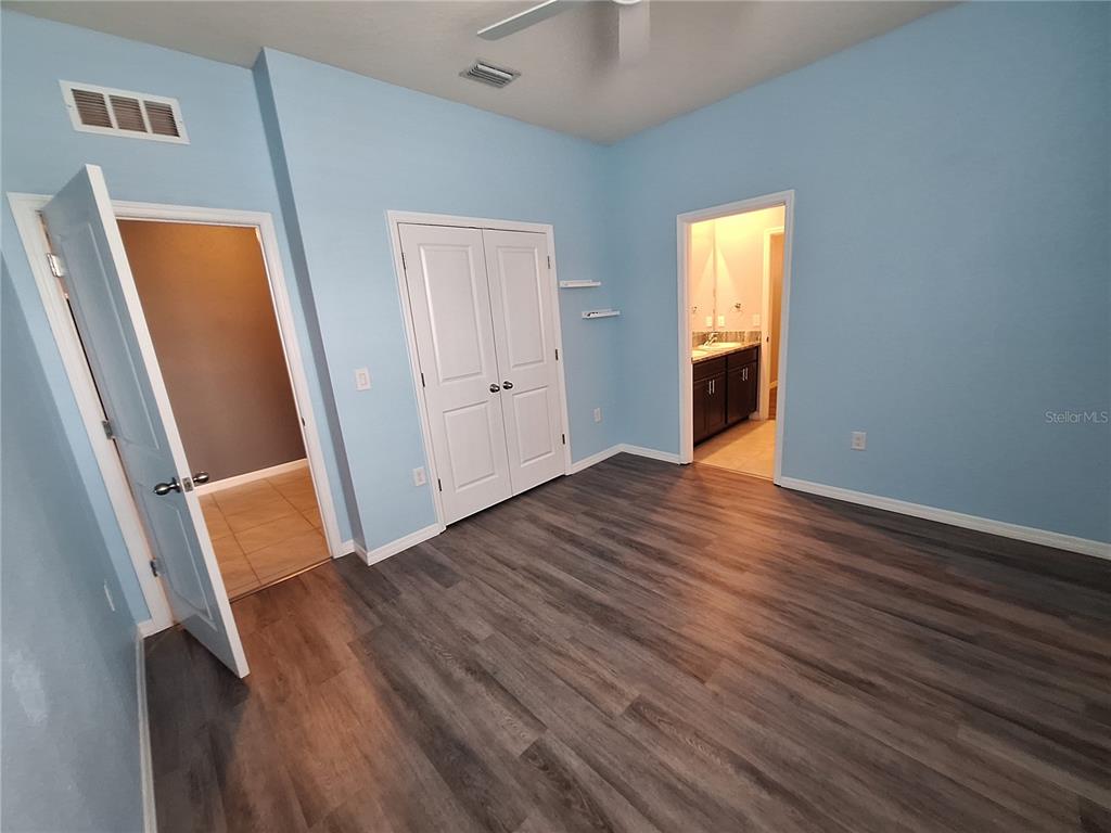 13483 Golden Lime Ave Spring Hill Spring Hill, FL 34609 - Photo 50 of 92 a view of an empty room with wooden floor and a window