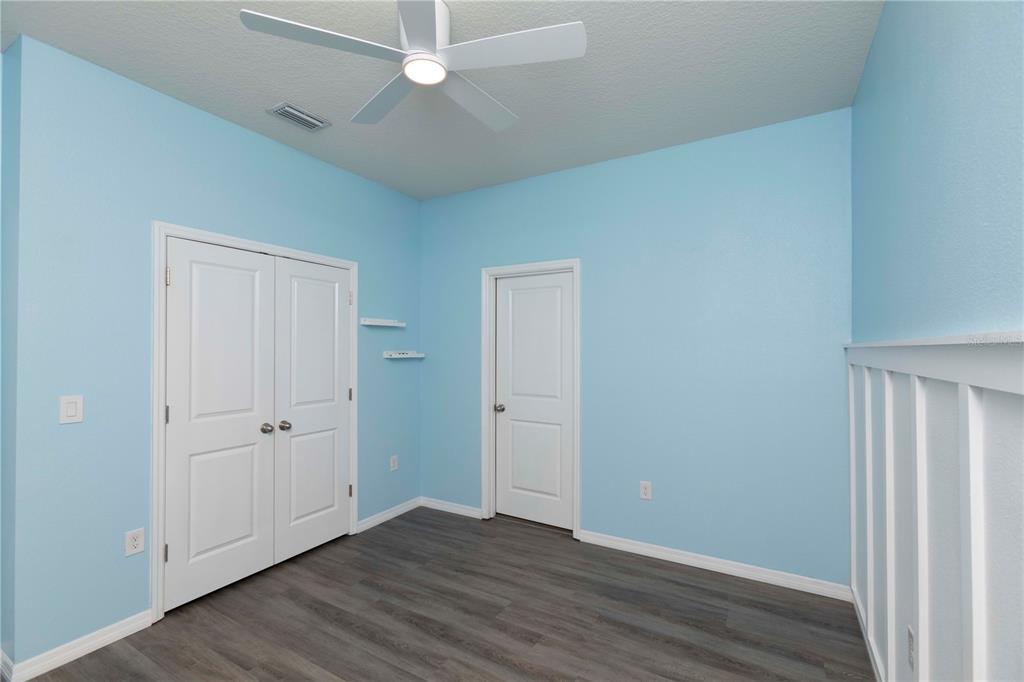 13483 Golden Lime Ave Spring Hill Spring Hill, FL 34609 - Photo 51 of 92 an empty room with wooden floor and windows