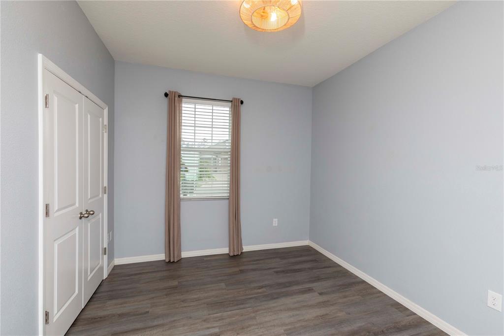 13483 Golden Lime Ave Spring Hill Spring Hill, FL 34609 - Photo 57 of 92 a view of an empty room with wooden floor and a window