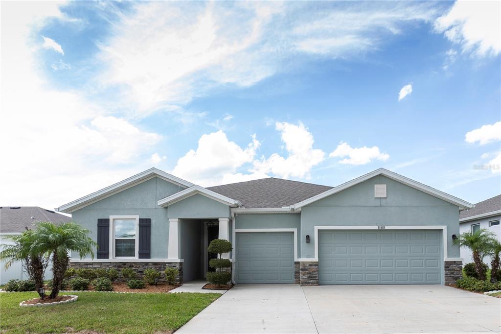 13483 Golden Lime Ave Spring Hill Spring Hill, FL 34609 - Photo 6 of 92 a front view of house with yard and trees