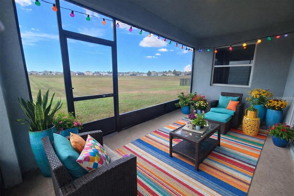 13483 Golden Lime Ave Spring Hill Spring Hill, FL 34609 - Photo 74 of 92 a living room filled with furniture and a floor to ceiling window