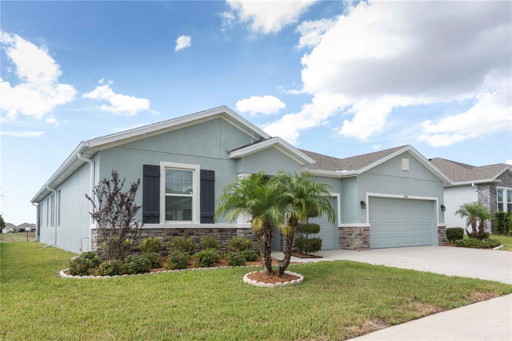 13483 Golden Lime Ave Spring Hill Spring Hill, FL 34609 - Photo 80 of 92 a front view of a house with a yard and garage