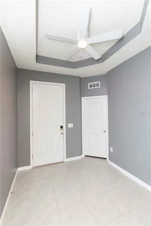 a view of an empty room with a fireplace and a window