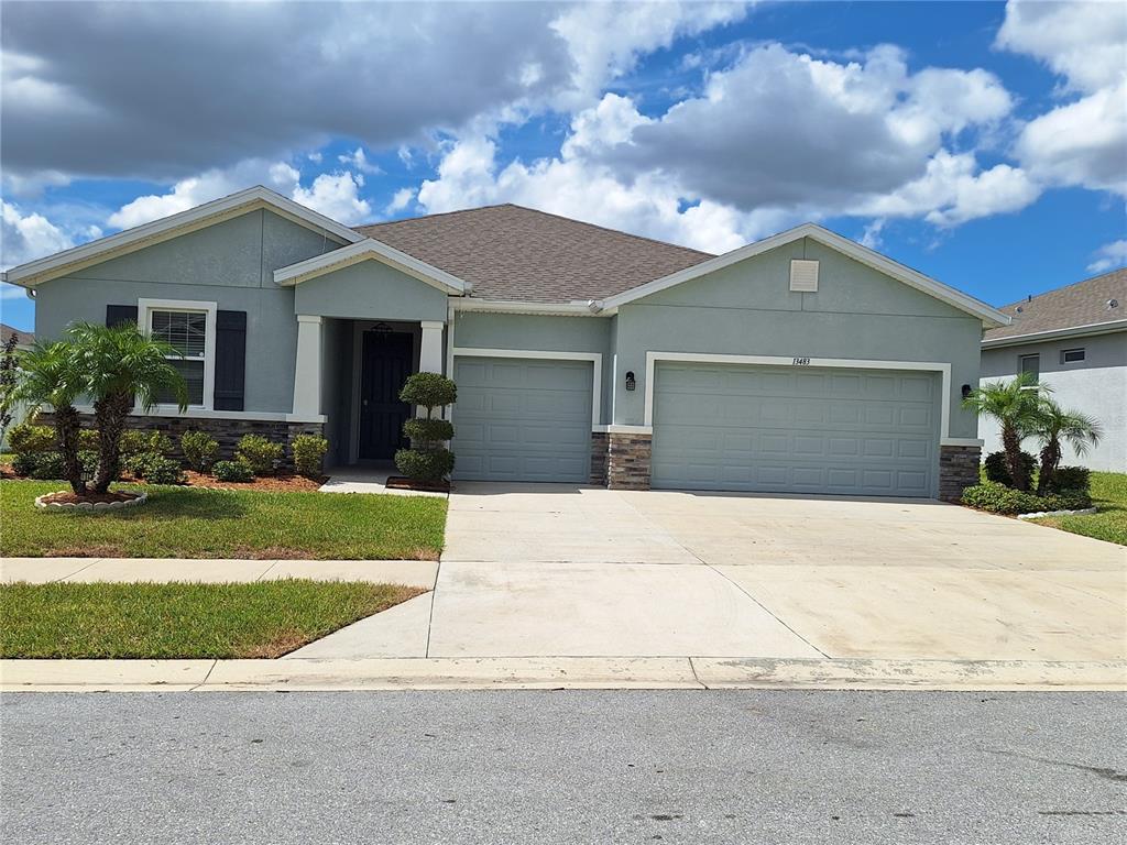 13483 Golden Lime Ave Spring Hill Spring Hill, FL 34609 - Photo 92 of 92 a front view of a house with a yard and garage