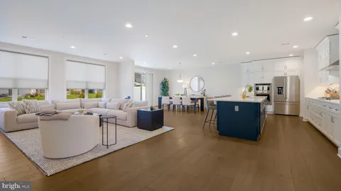 a living room with lots of furniture and kitchen view